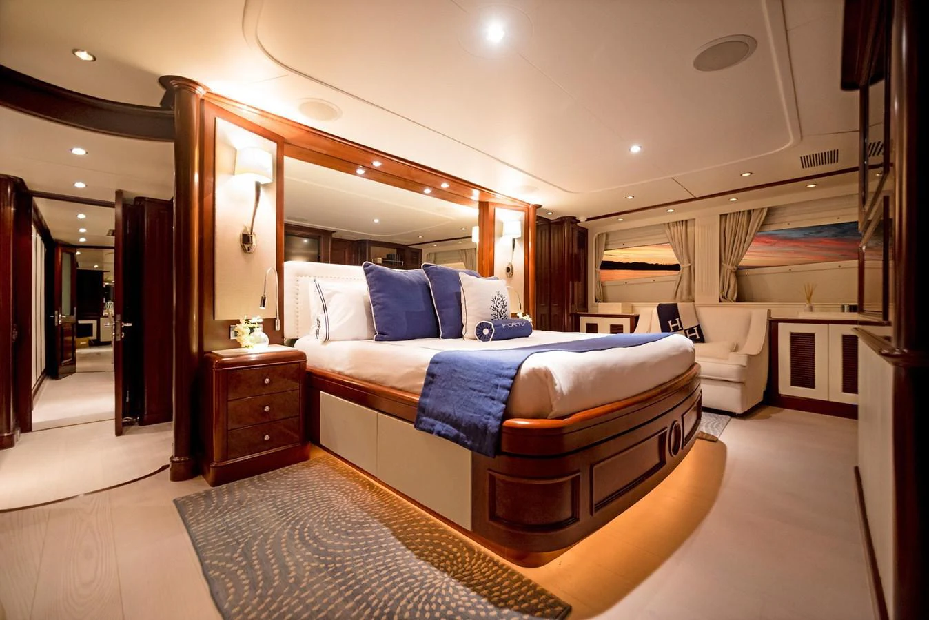 a bedroom with a bed and a mirror aboard GITANA Yacht for Sale