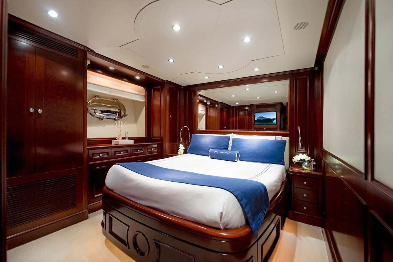 a bedroom with a bed and a wood door aboard GITANA Yacht for Sale