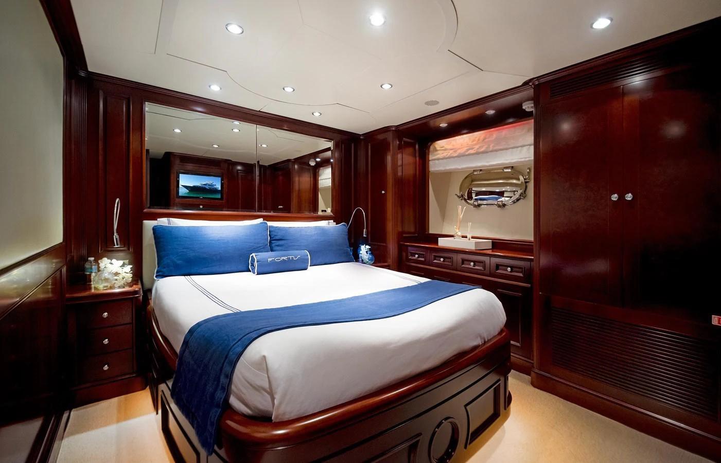 a bedroom with a bed and a dresser aboard GITANA Yacht for Sale