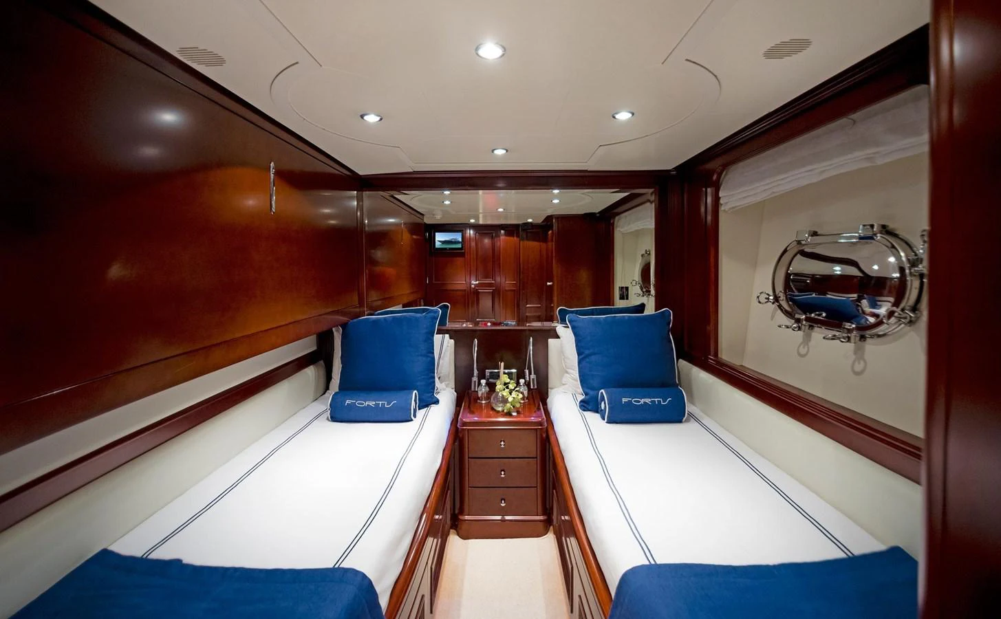 inside of a room with a bed and a dresser aboard GITANA Yacht for Sale