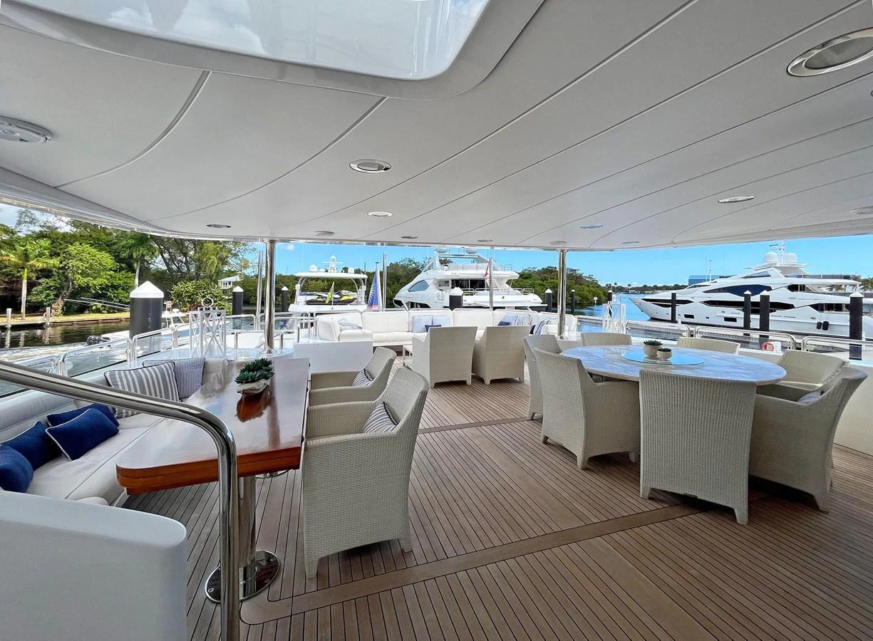 a room with a table chairs and a large body of water aboard GITANA Yacht for Sale