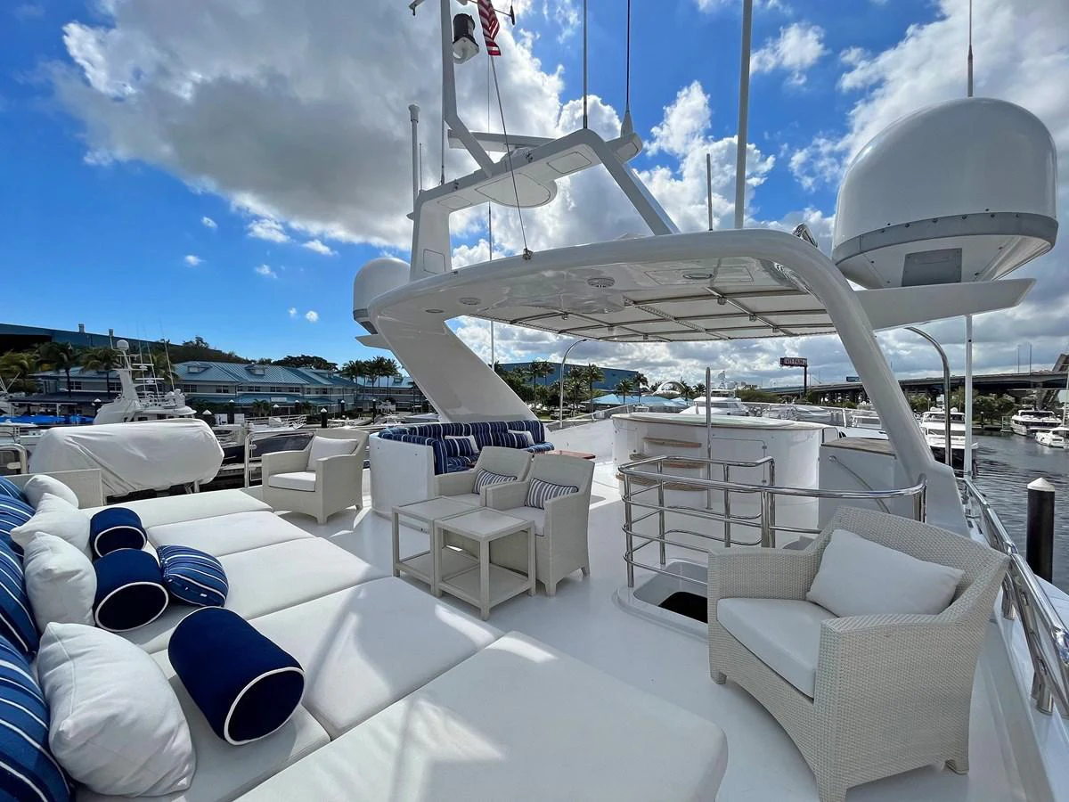 a large white lounge area with a large white umbrella and chairs on it aboard GITANA Yacht for Sale