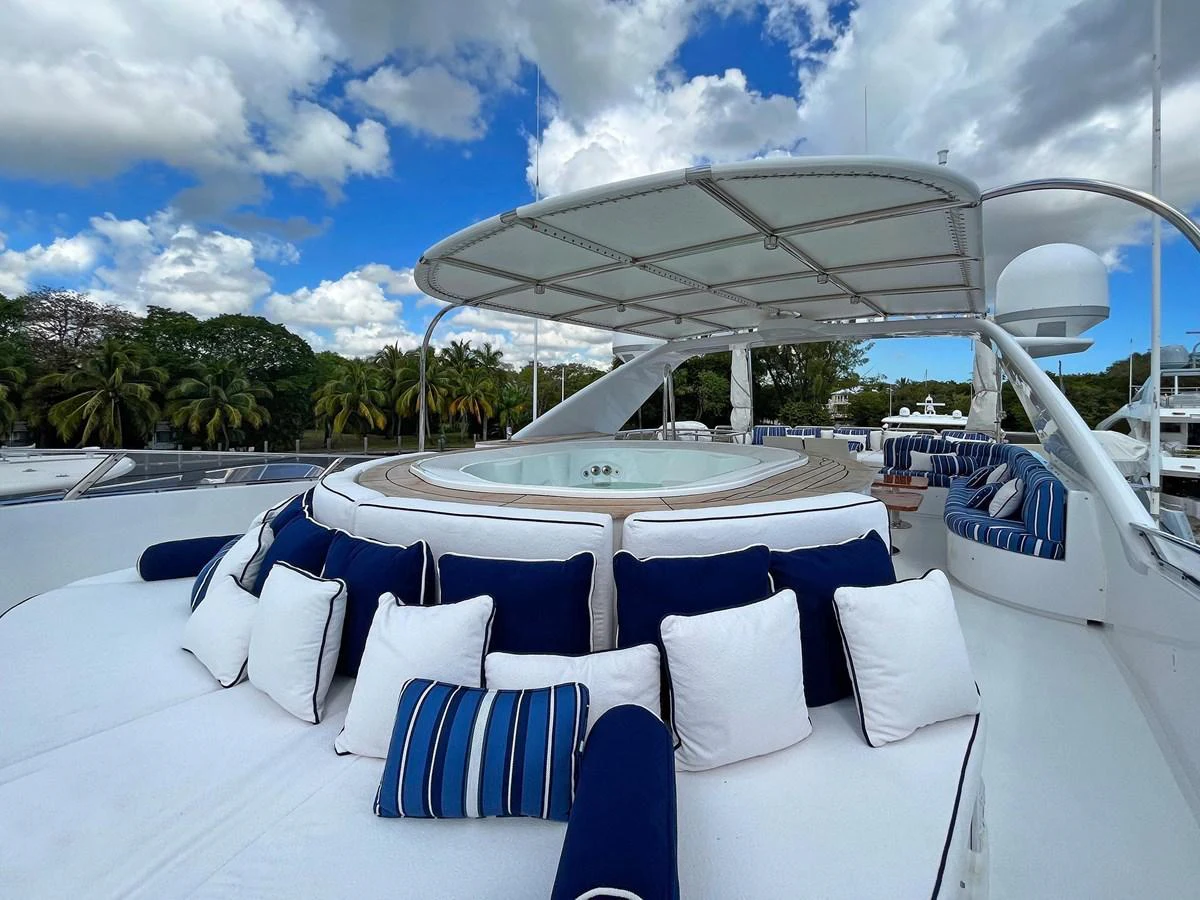 a lounge area with a large white lounge chair and a large white umbrella aboard GITANA Yacht for Sale