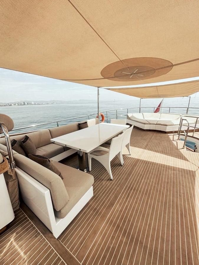a room with a couch and a table and chairs aboard LAZIZA Yacht for Sale