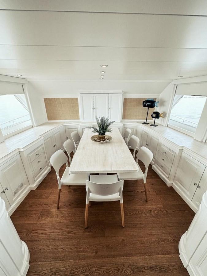 a dining room with white chairs aboard LAZIZA Yacht for Sale