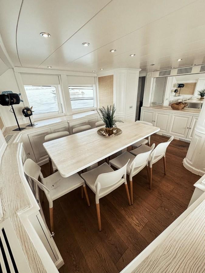 a kitchen with a dining table aboard LAZIZA Yacht for Sale