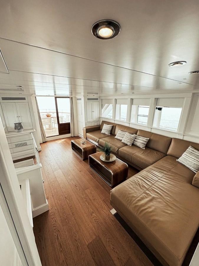 a living room with a wood floor aboard LAZIZA Yacht for Sale