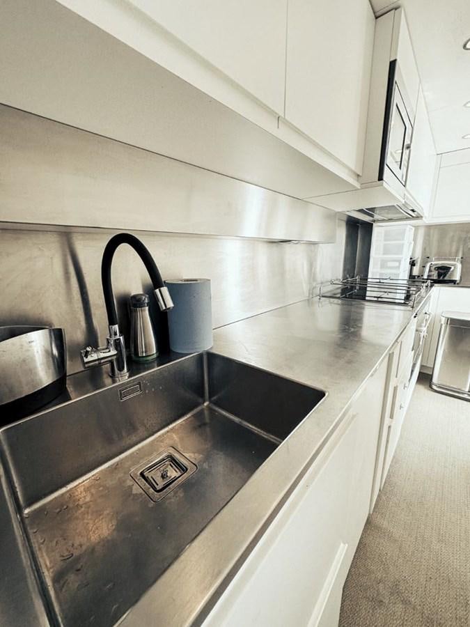 a kitchen with stainless steel appliances aboard LAZIZA Yacht for Sale