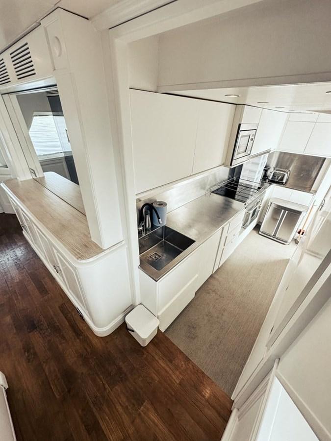 a kitchen with a sink and a refrigerator aboard LAZIZA Yacht for Sale