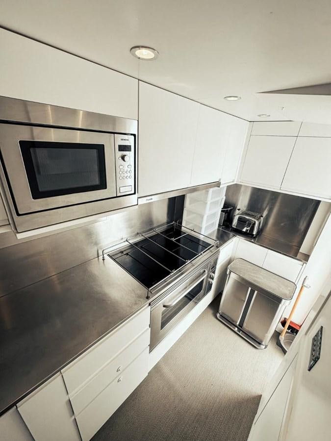 a kitchen with a microwave oven and stove aboard LAZIZA Yacht for Sale