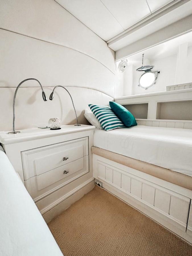 a white bedroom with a white bed aboard LAZIZA Yacht for Sale