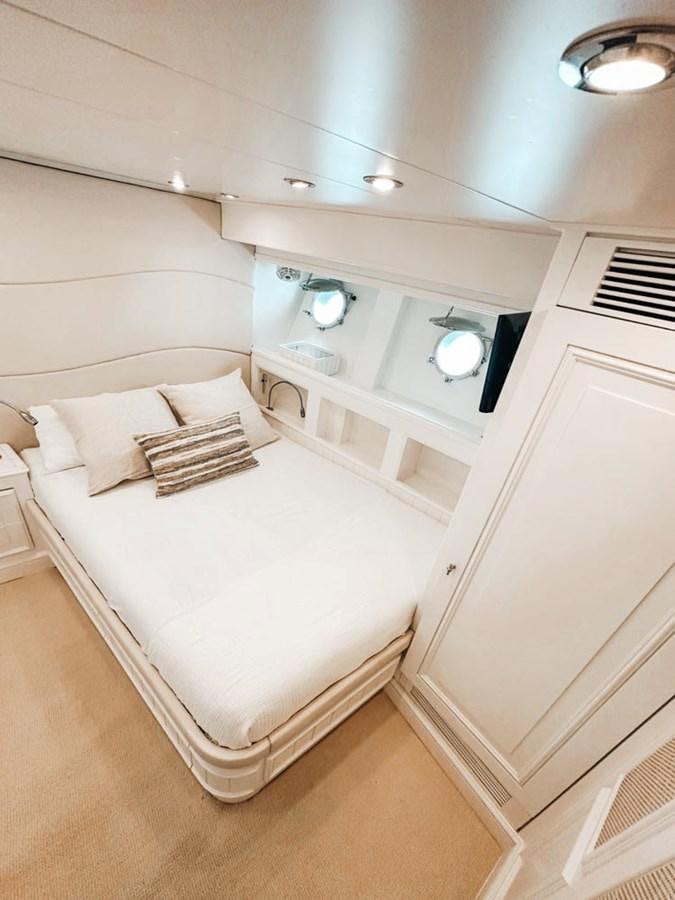 a white bedroom with a bed aboard LAZIZA Yacht for Sale