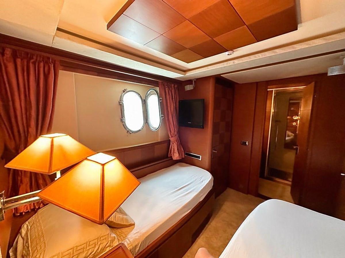 a room with a bed and a television aboard AZIMUT 116/32 Yacht for Sale