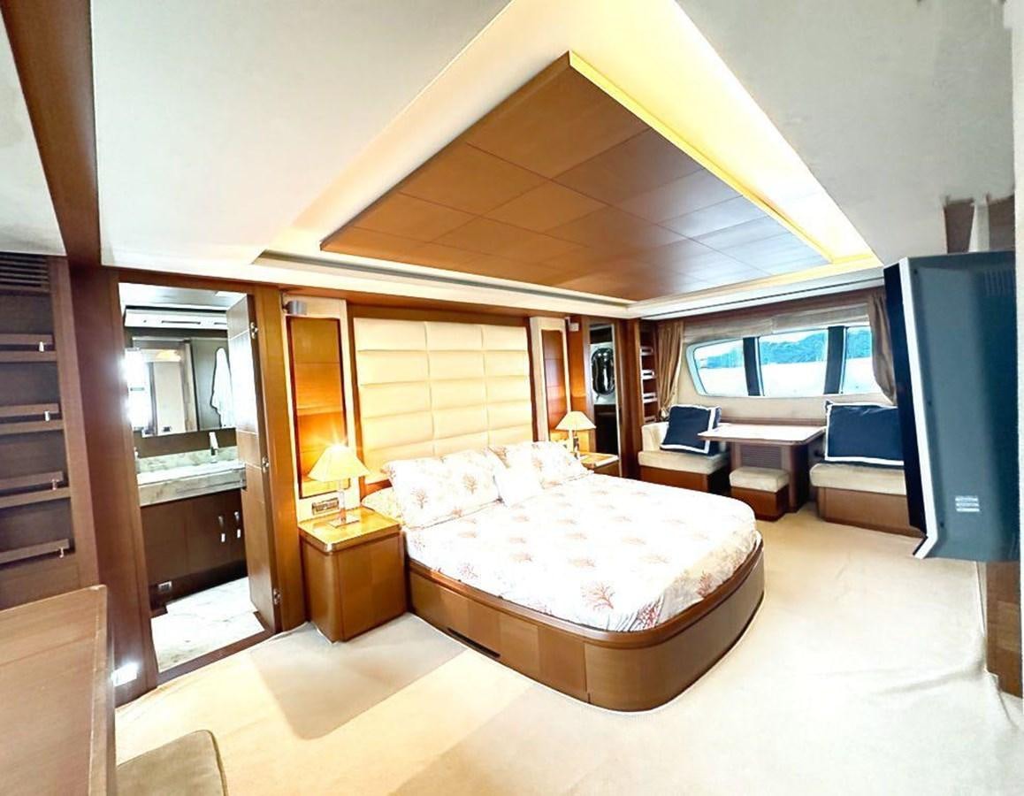 a bedroom with a bed and a tv aboard AZIMUT 116/32 Yacht for Sale