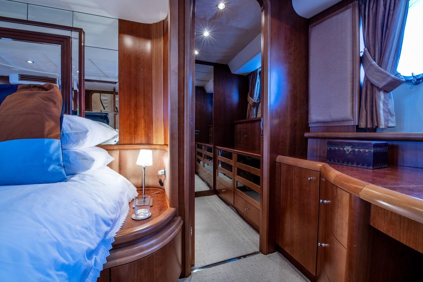 a bedroom with a bed and a desk aboard TIME OUT OF LONDON Yacht for Sale