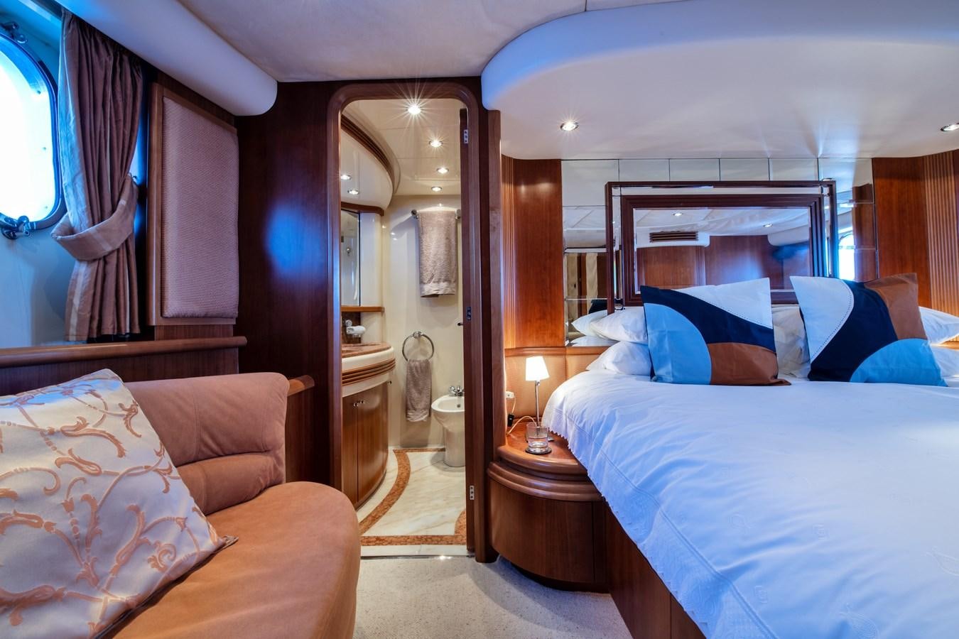 a room with a bed and a mirror aboard TIME OUT OF LONDON Yacht for Sale