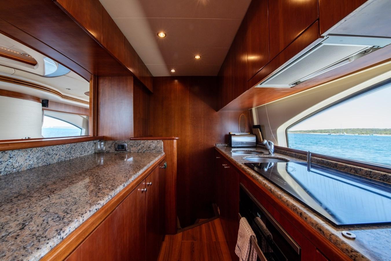 a kitchen with a large island aboard TIME OUT OF LONDON Yacht for Sale