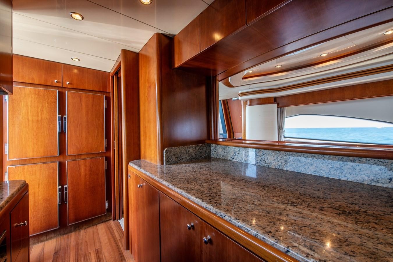 a kitchen with wooden cabinets aboard TIME OUT OF LONDON Yacht for Sale