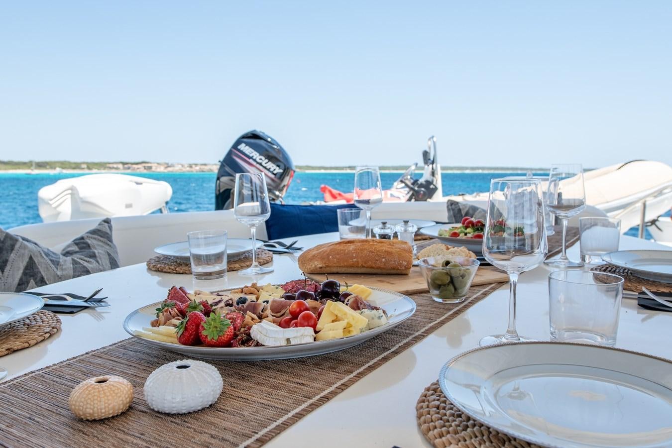 a table with food and wine on it aboard TIME OUT OF LONDON Yacht for Sale