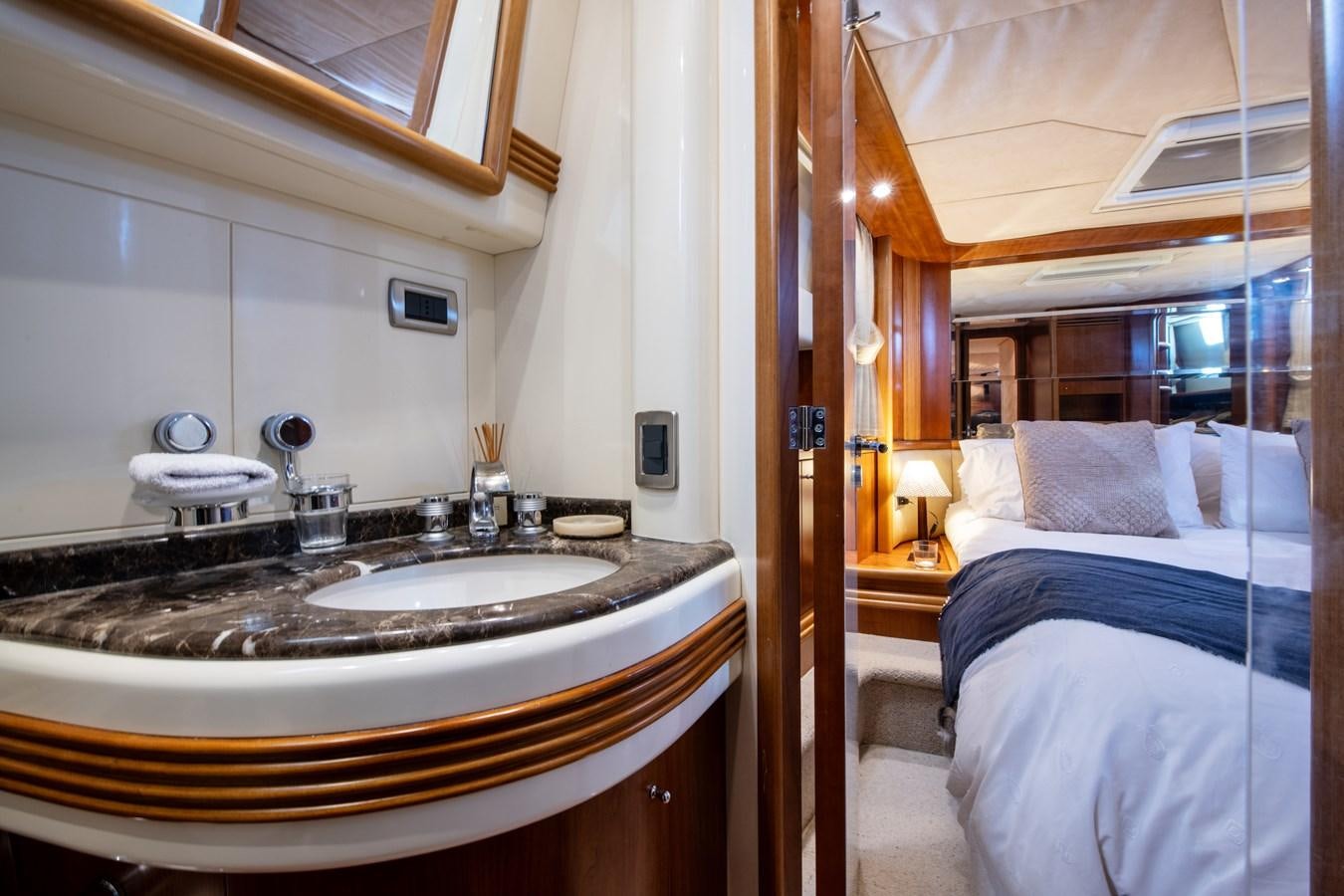 a bathroom with a sink and a bed aboard TIME OUT OF LONDON Yacht for Sale
