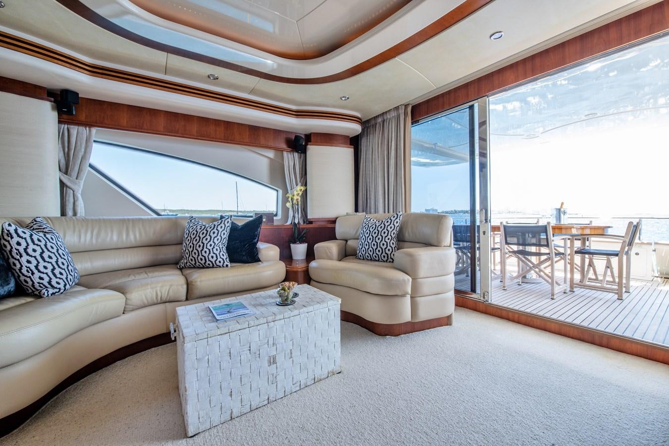a living room with a large window aboard TIME OUT OF LONDON Yacht for Sale