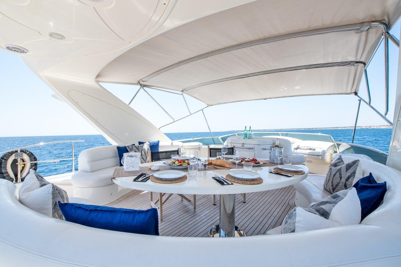 a tent with a table and chairs aboard TIME OUT OF LONDON Yacht for Sale
