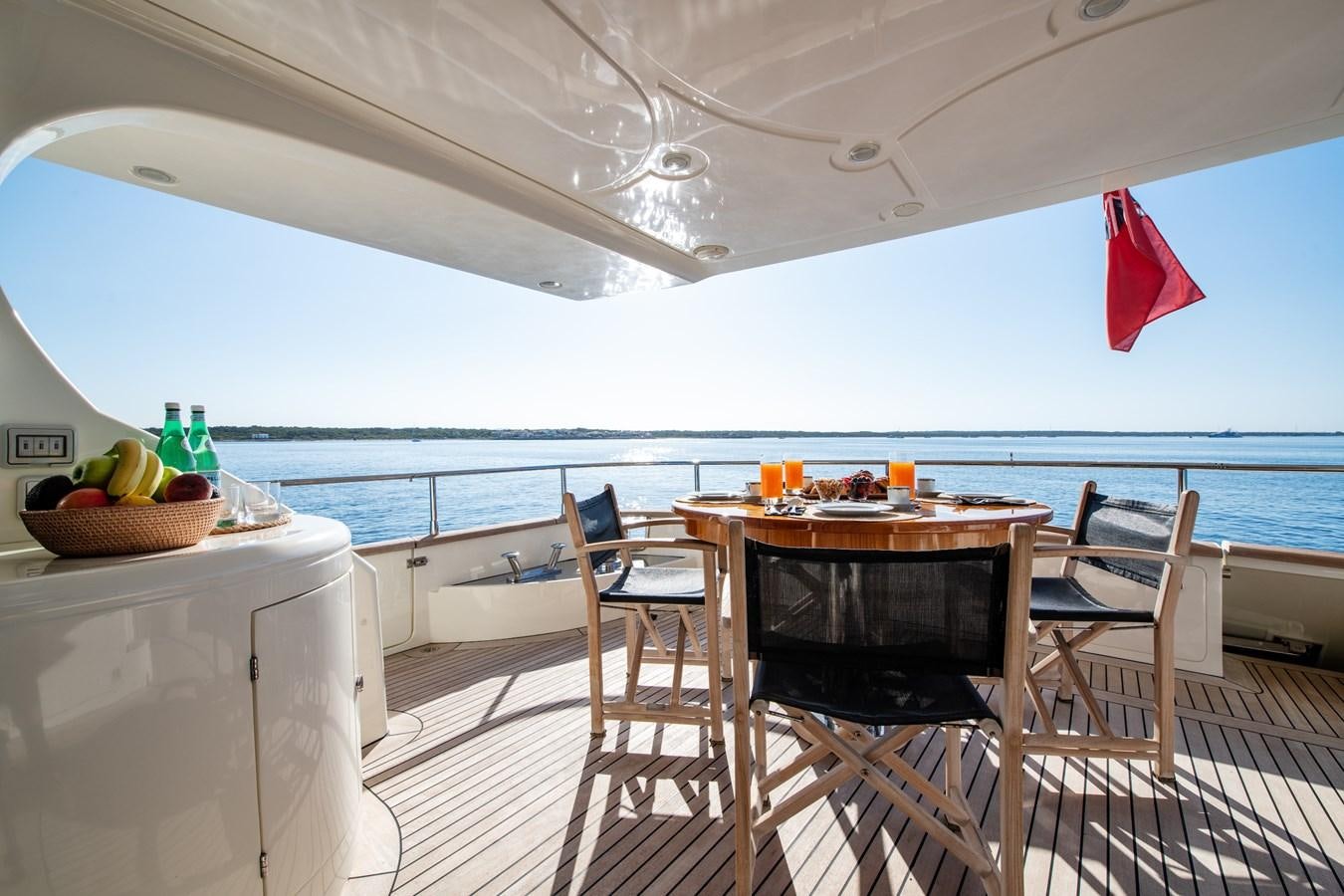 a table and chairs on a deck aboard TIME OUT OF LONDON Yacht for Sale