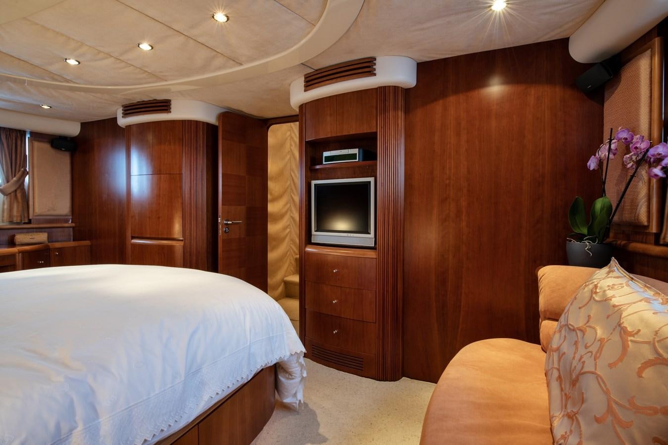 a bedroom with a bed and a television aboard TIME OUT OF LONDON Yacht for Sale