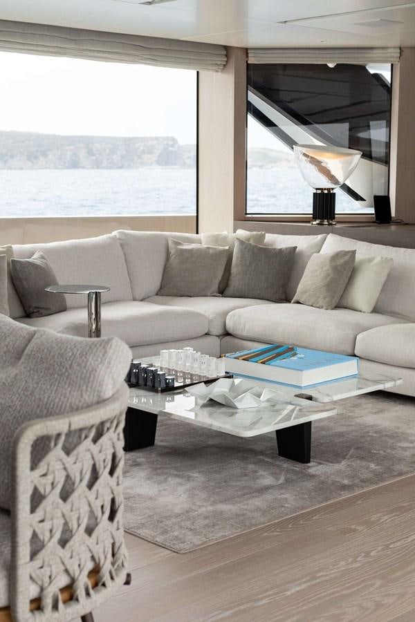 a living room with a couch and a coffee table aboard 2022 SANLORENZO SL120A Yacht for Sale