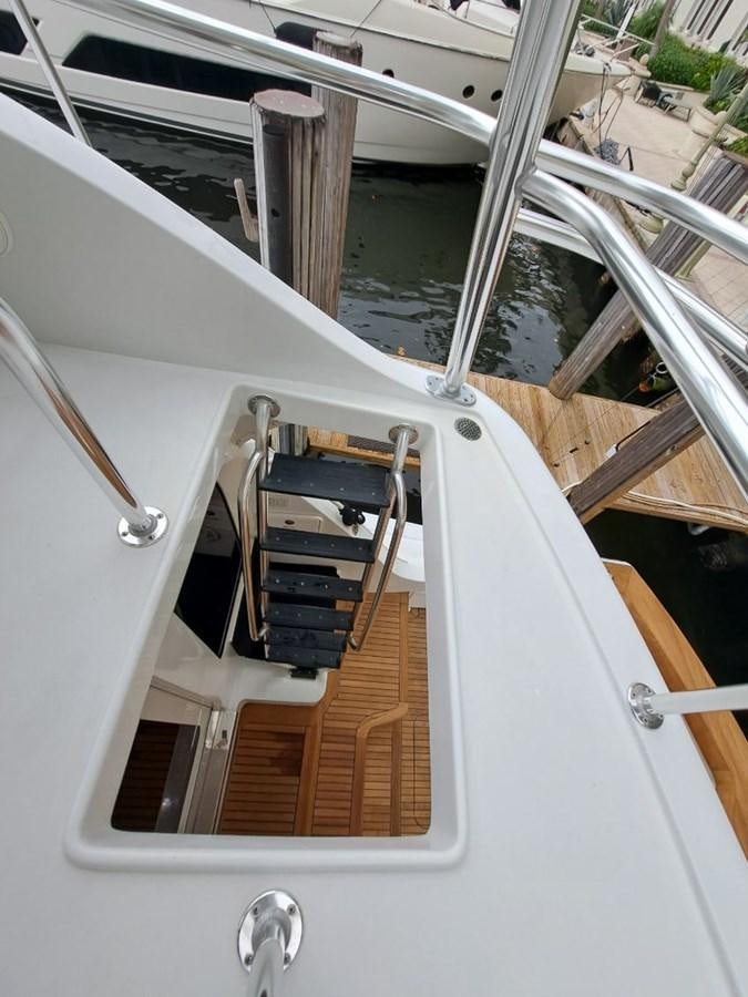 a boat with a steering wheel aboard CLAIRE TOO Yacht for Sale
