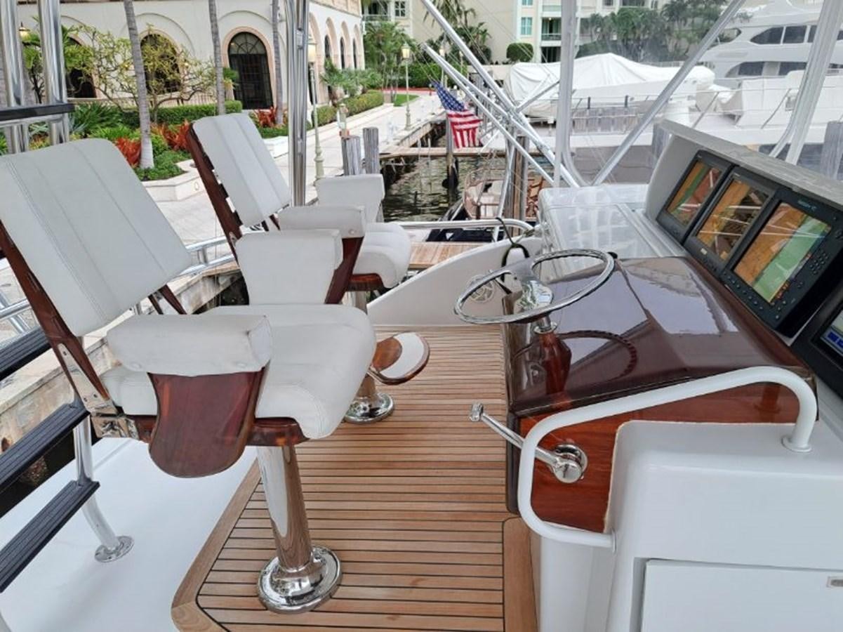 a table with chairs and a drink on it aboard CLAIRE TOO Yacht for Sale