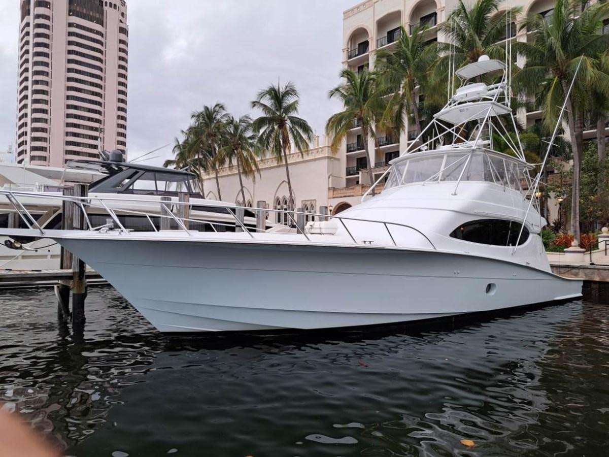 a white yacht in a harbor aboard CLAIRE TOO Yacht for Sale