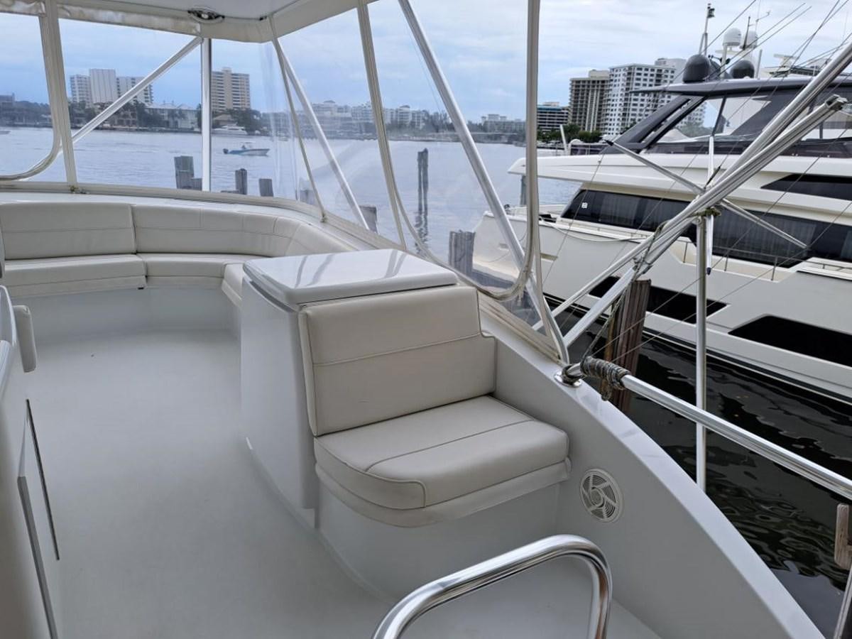 a white boat with a chair on the deck aboard CLAIRE TOO Yacht for Sale