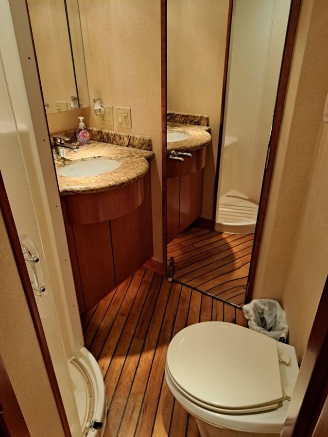 a bathroom with a toilet and sink aboard CLAIRE TOO Yacht for Sale