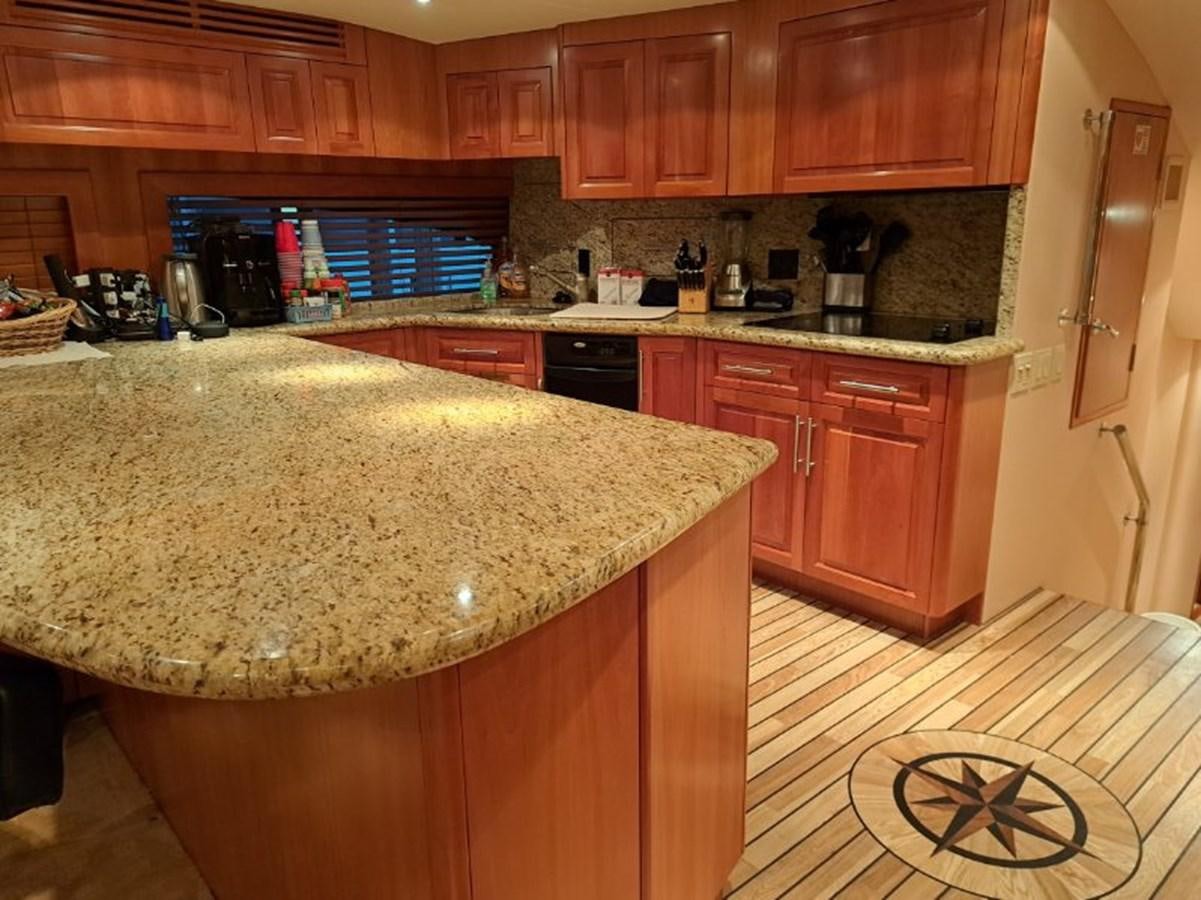 a kitchen with wooden cabinets aboard CLAIRE TOO Yacht for Sale