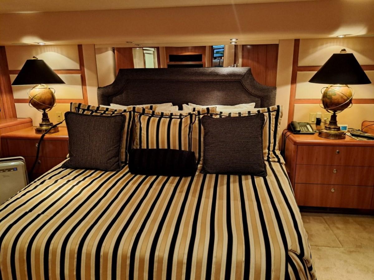 a bed with a black and white striped blanket aboard CLAIRE TOO Yacht for Sale