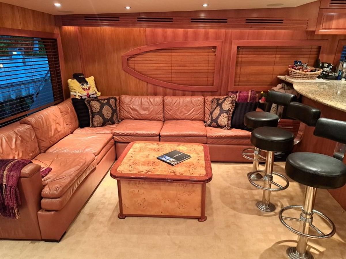 a living room with a couch and coffee table aboard CLAIRE TOO Yacht for Sale