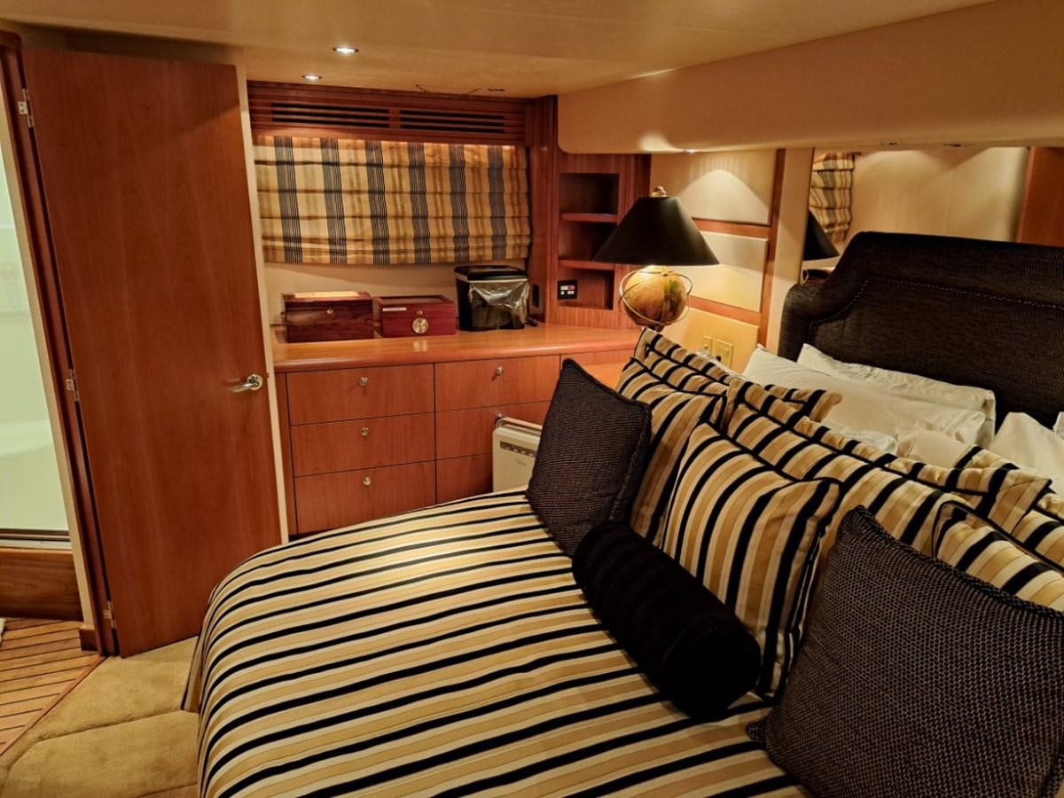 a bedroom with a bed and a desk aboard CLAIRE TOO Yacht for Sale
