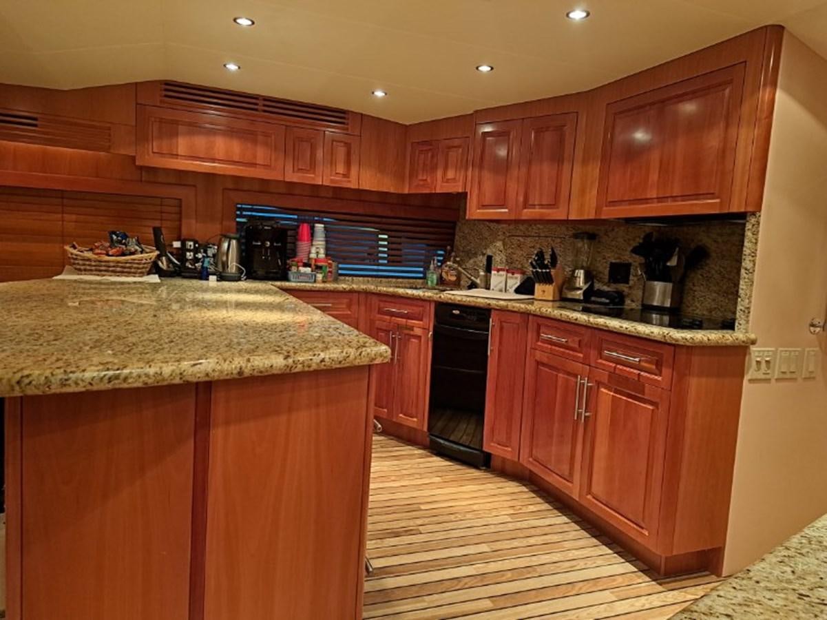 a kitchen with wooden cabinets aboard CLAIRE TOO Yacht for Sale