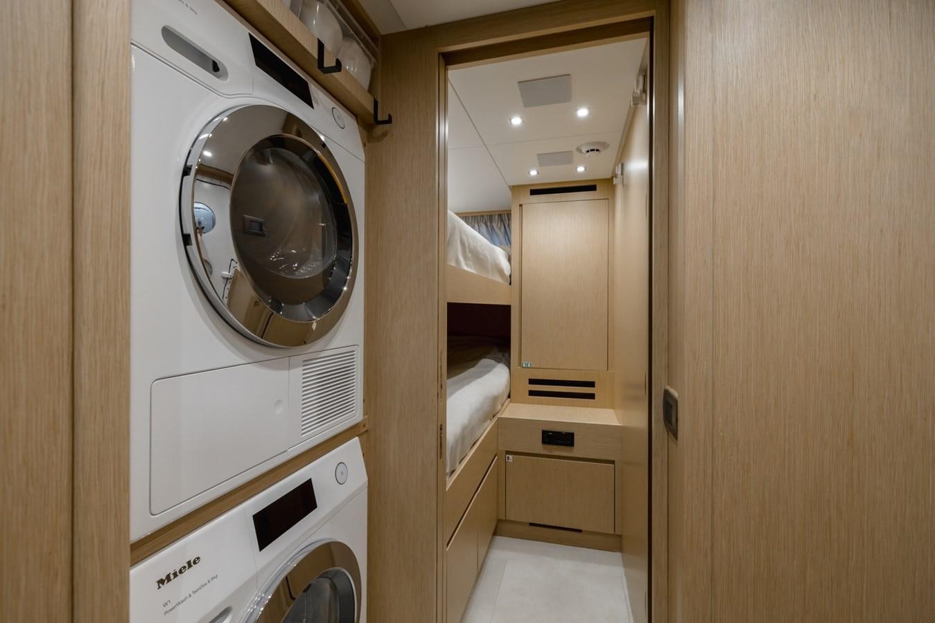 a room with a washing machine and dryer aboard RADKAT Yacht for Sale