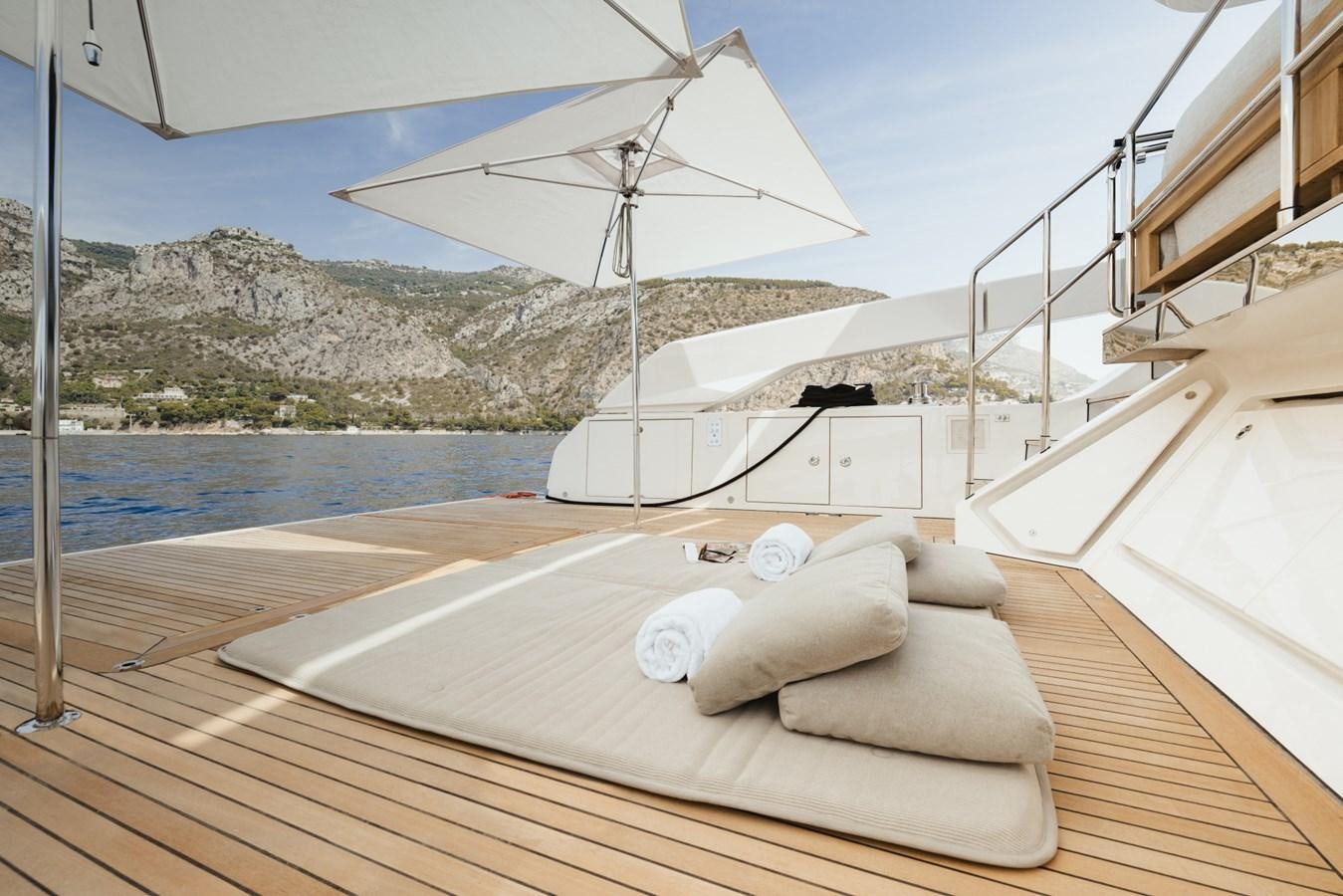 a bed on a deck aboard RADKAT Yacht for Sale