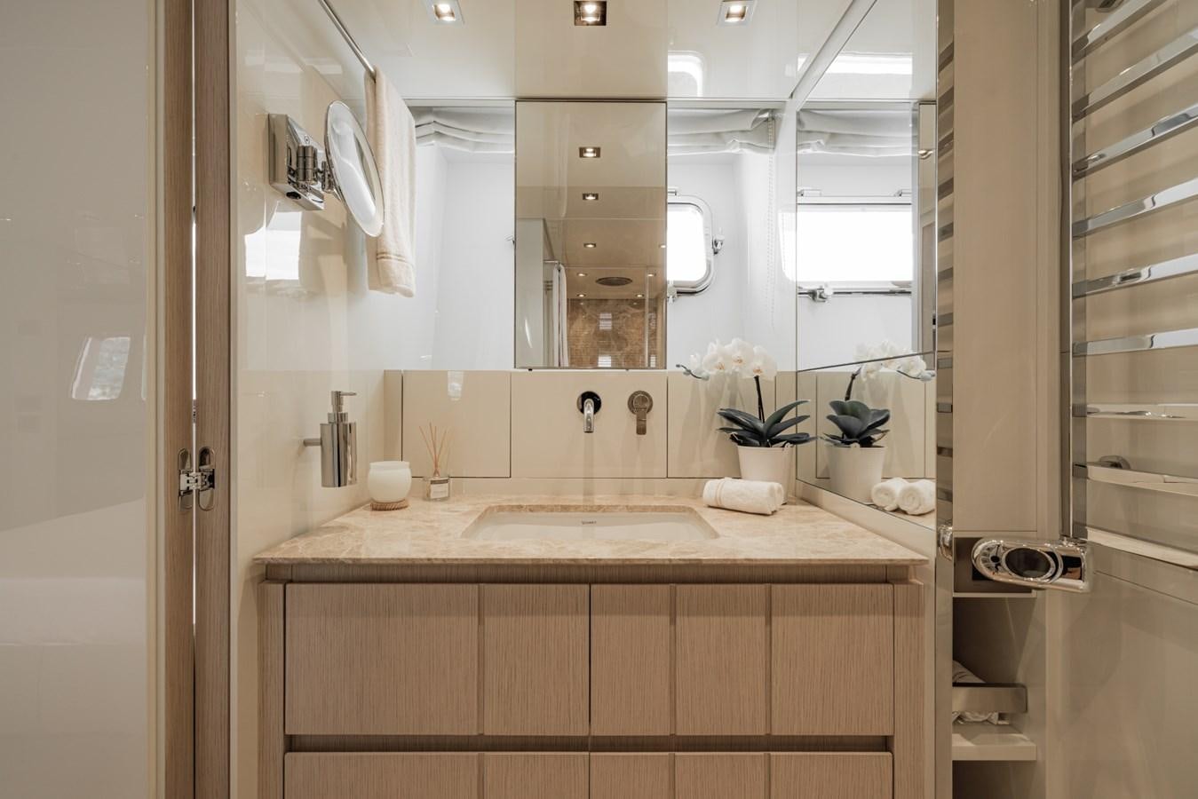 a bathroom with a large mirror aboard RADKAT Yacht for Sale