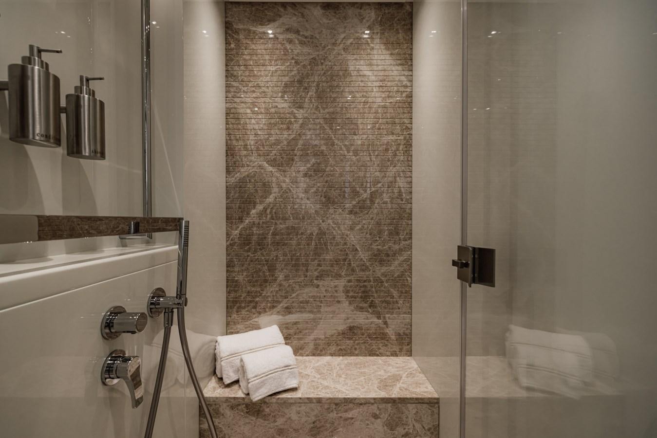a bathroom with a glass shower aboard RADKAT Yacht for Sale