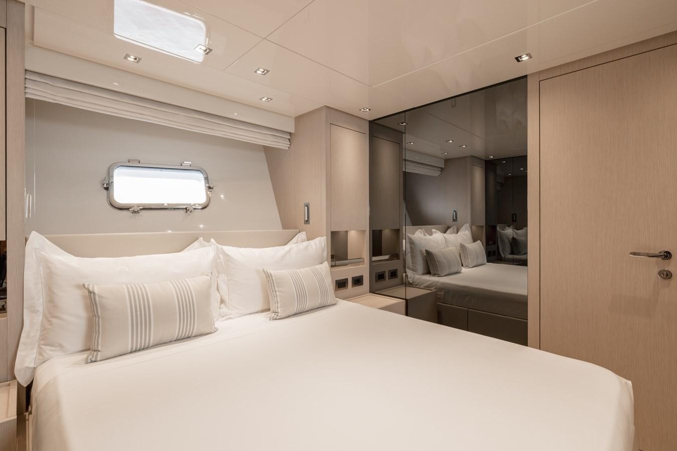 a room with a bed and a mirror aboard RADKAT Yacht for Sale