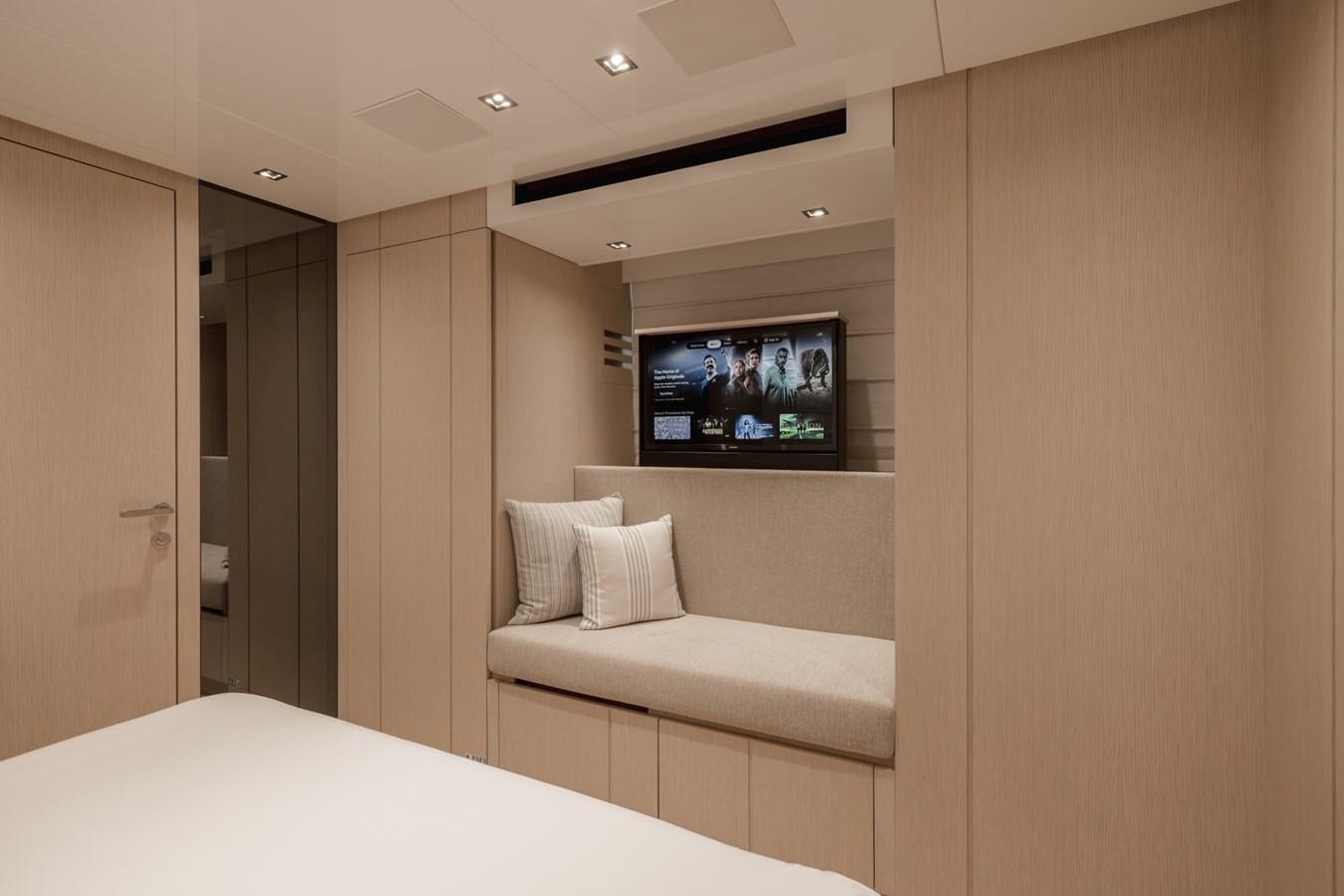 a room with a bed and a television aboard RADKAT Yacht for Sale
