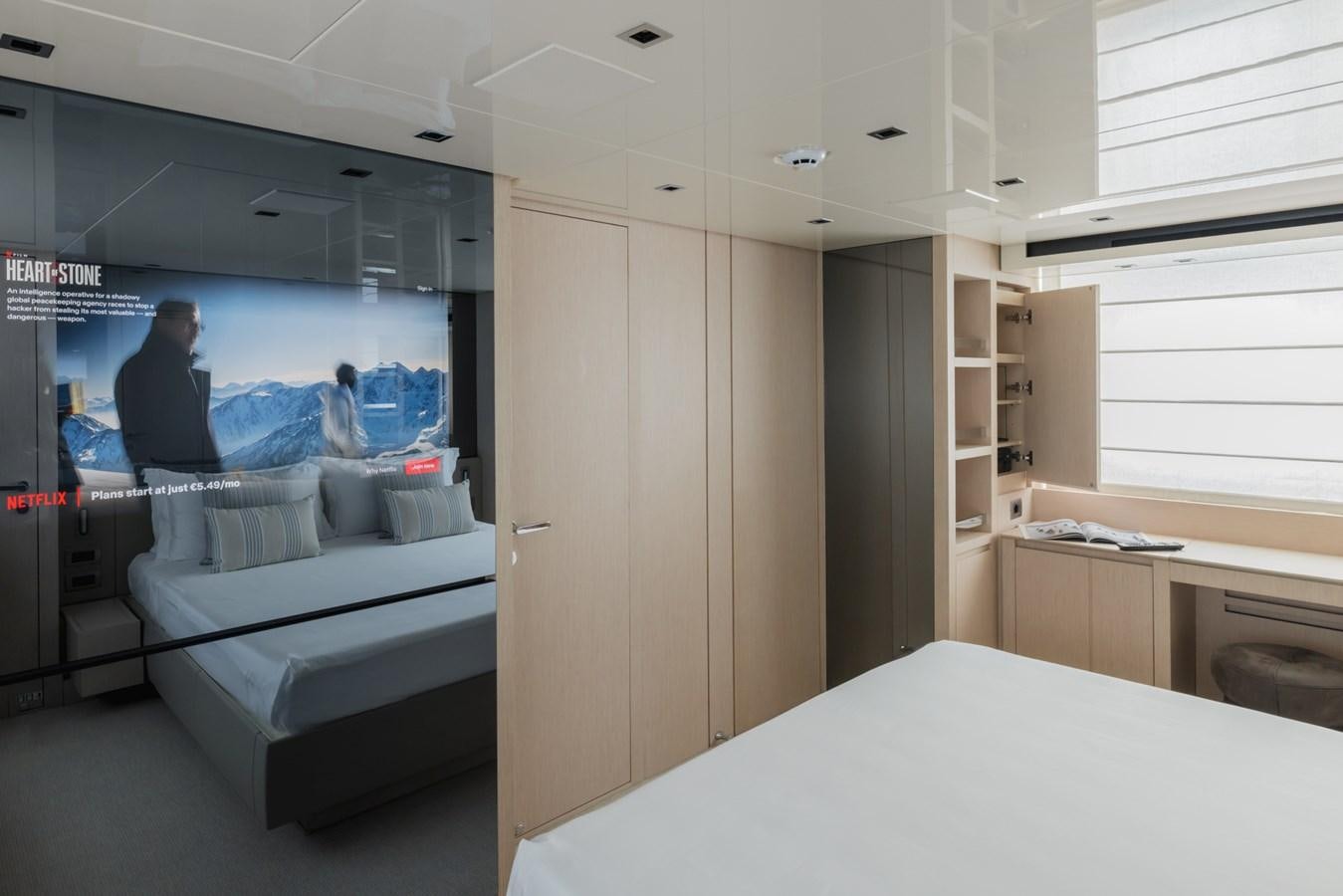 a room with a bed and a desk aboard RADKAT Yacht for Sale