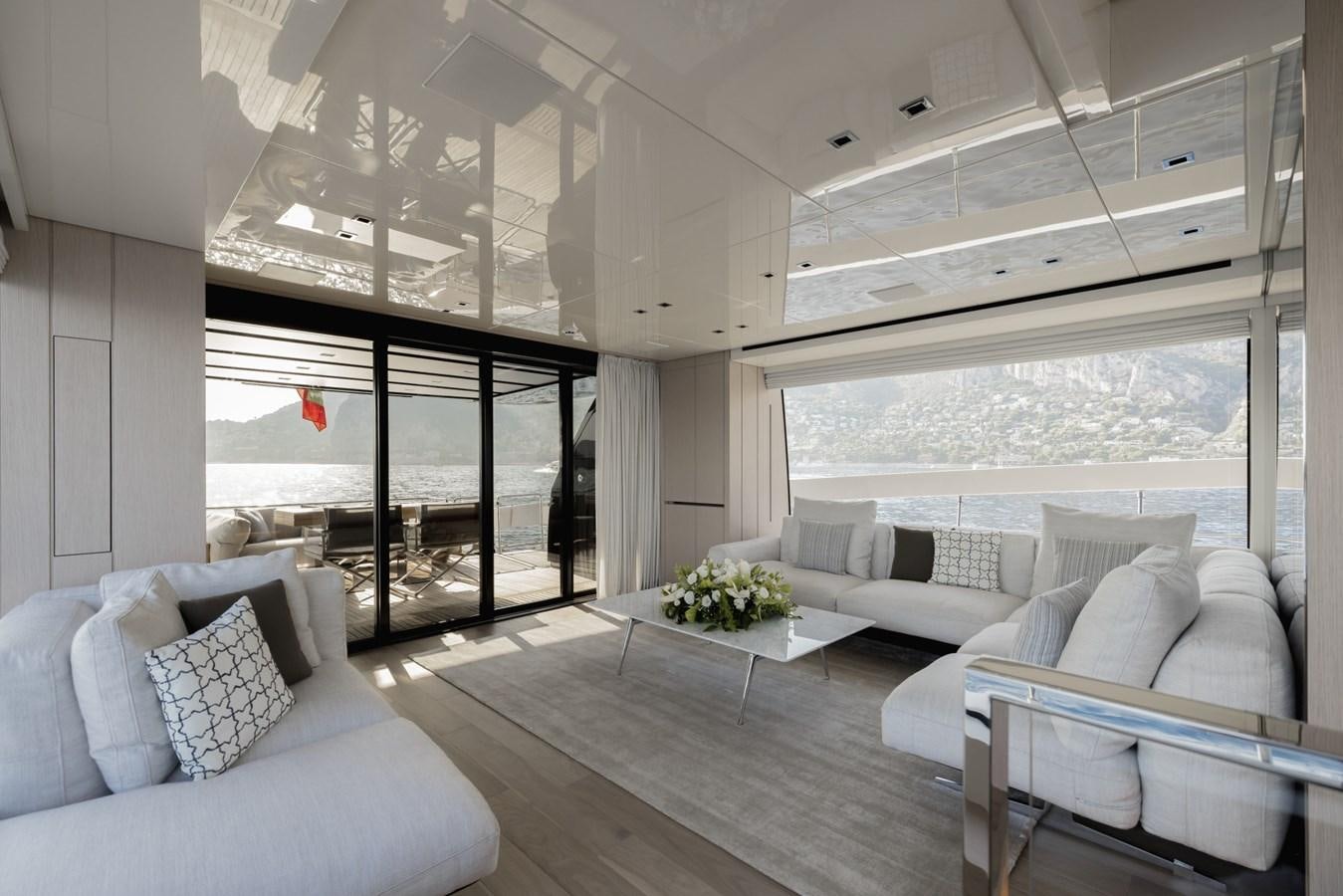 a living room with white couches aboard RADKAT Yacht for Sale