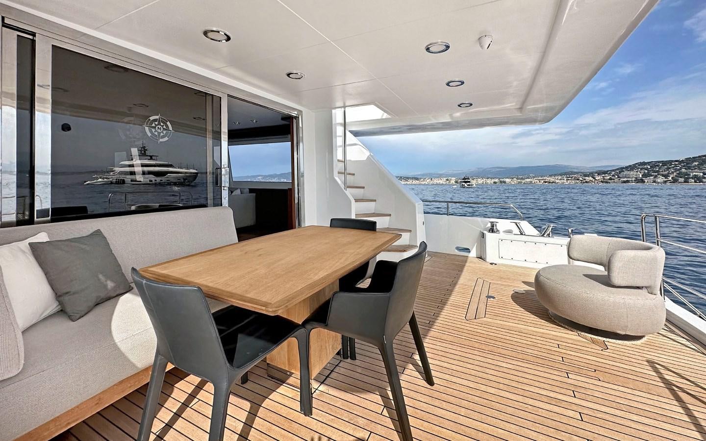 a room with a table and chairs aboard LORCA Yacht for Sale