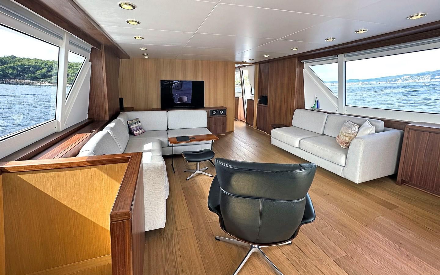 a living room with a couch and a tv aboard LORCA Yacht for Sale