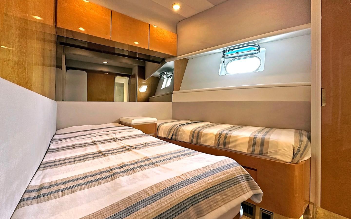 a room with a bed and a desk aboard LORCA Yacht for Sale